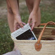 person pulling forty ways to know a star book out of a basket
