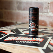 Deodorant stick with Brooklyn Grooming branding on a wooden surface with branded cards.