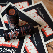 Two deodorant sticks on promotional material for a grooming brand.