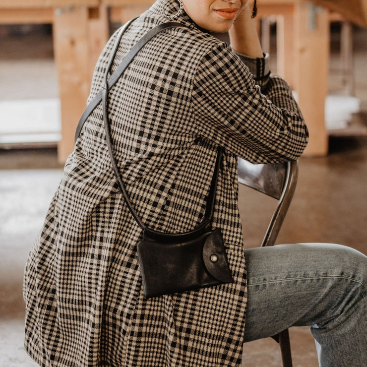 Model wearing black phone holster made by The Local Branch