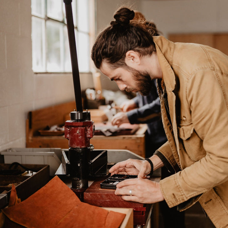 Head designer and craftsman Blaine Vossler making a leather holster