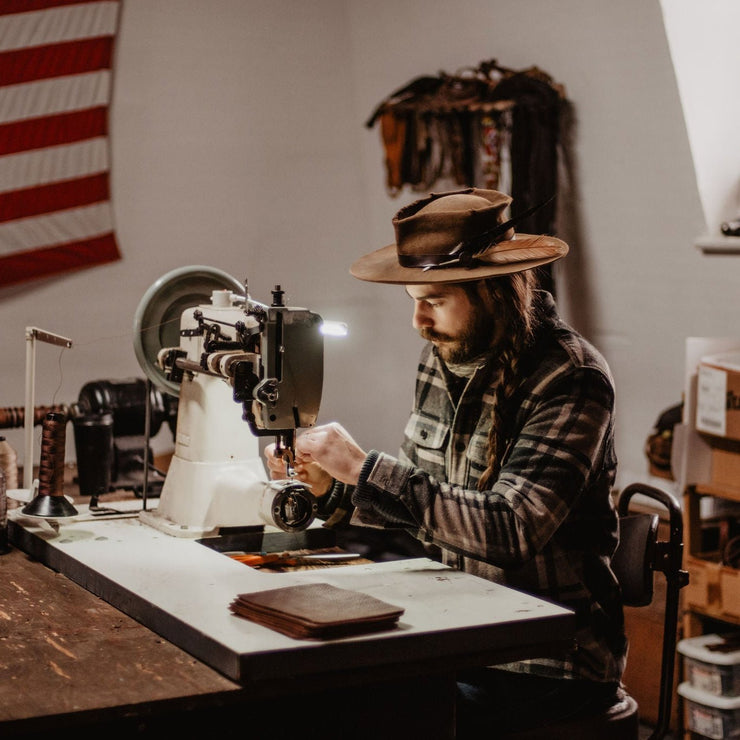 Blaine working on leather journals