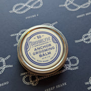 Anchor Grooming Balm container on a blue background with rope patterns