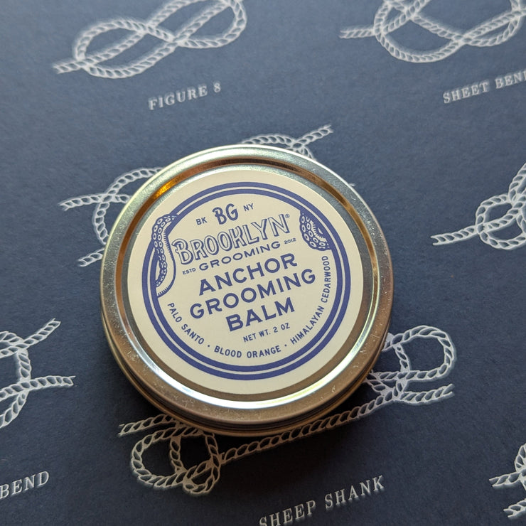 Anchor Grooming Balm container on a blue background with rope patterns