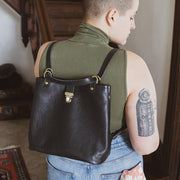 black leather convertible backpack on model