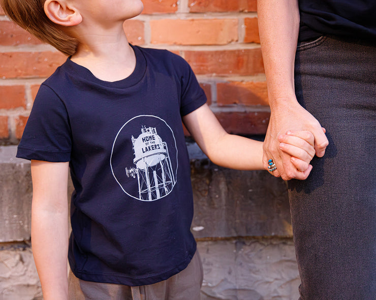 Home of the Lakers Water Tower kids tee in navy blue holding hands 