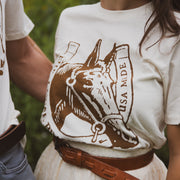 Person wearing a cream t-shirt with a horse graphic and 'USA Made' text.
