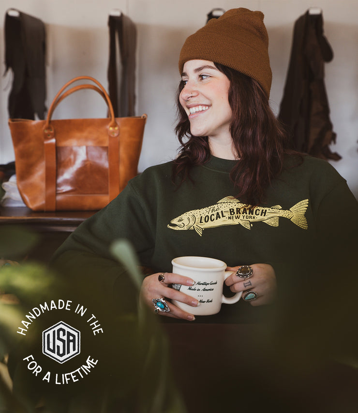 100% cotton forest green crewneck with cream colored screen printed says the local branch New York made in the us
