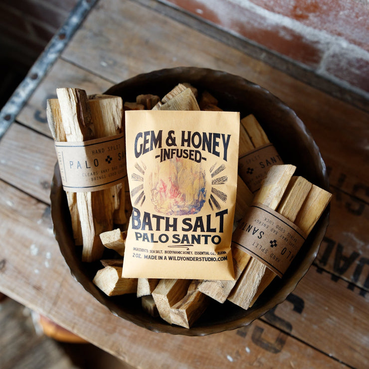Bowl of Gem & Honey Infused Bath Salt Palo Santo on a rustic wooden surface.