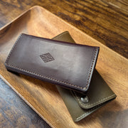 USA handcrafted leather pocket books in olive and chocolate back side with the local branch logo stamped. 
