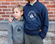 Two children wearing matching Hard to Say Easy to Love hoodies made by The Local Branch