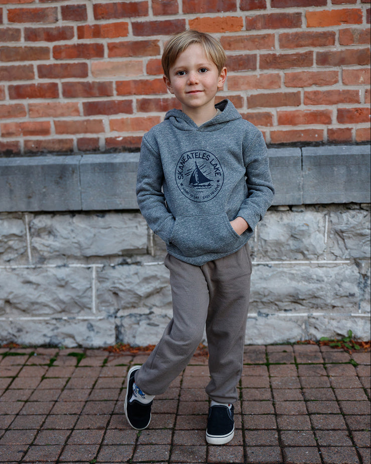 Hard to Say Easy to Love gray hoodie made by The Local Branch worn by a child in front of a brick wall.