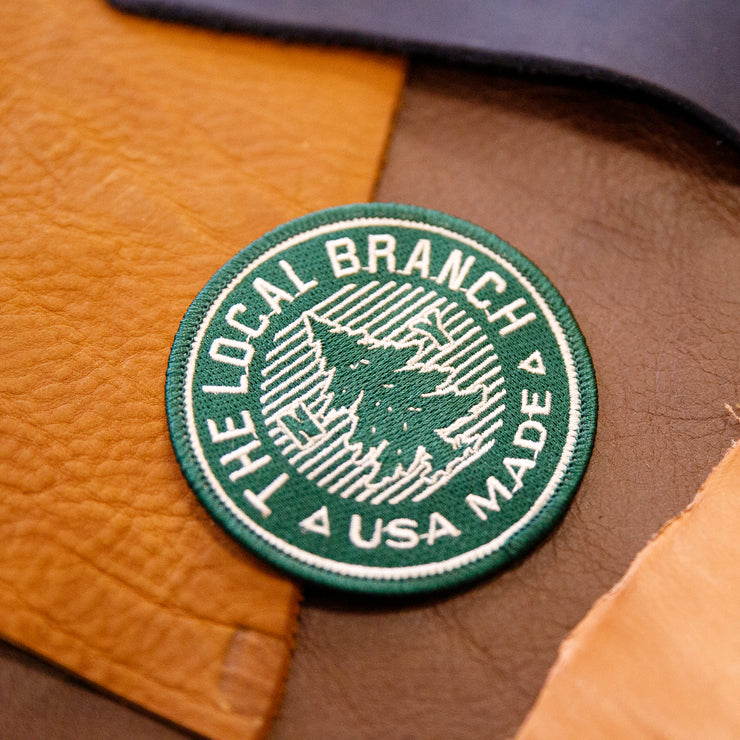 Green patch, white writing the local branch USA made pine tree in middle
