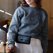 wanderer bag in the workshop on a model wearing NYS sweatshirt