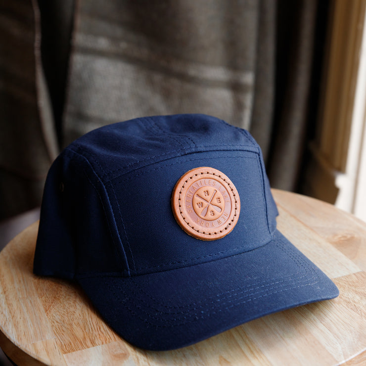 5-panel hat navy with leather skaneateles lake crossed paddles and compass patch