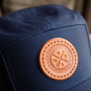 5-panel hat navy with leather skaneateles lake crossed paddles and compass patch