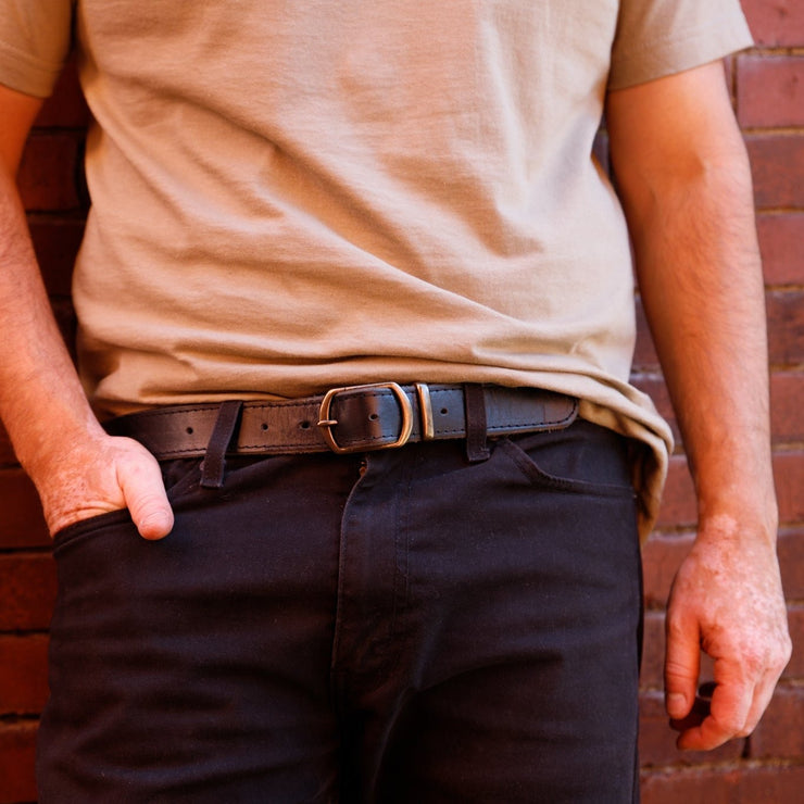 stitched detail around black belt with brass buckle