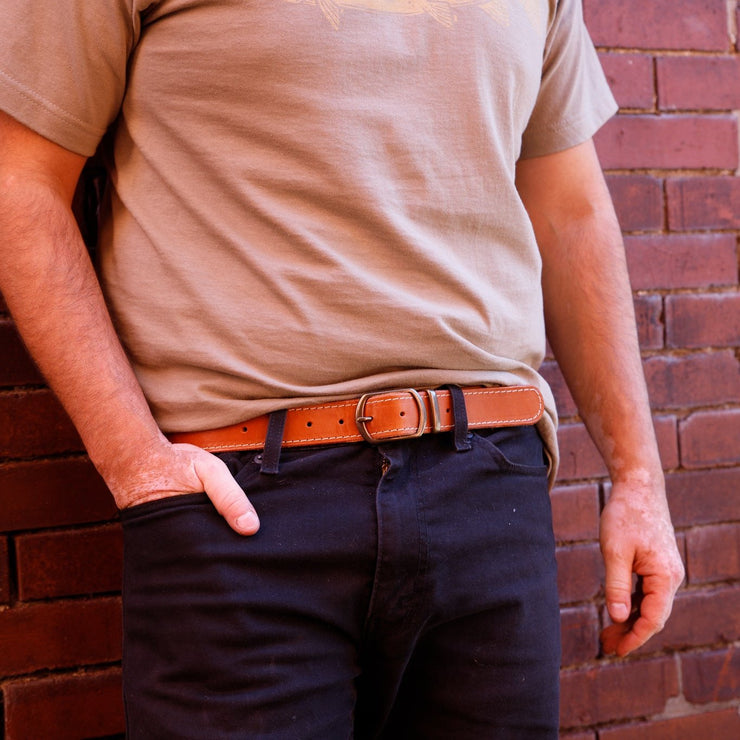 stitched detail around caramel belt with brass buckle