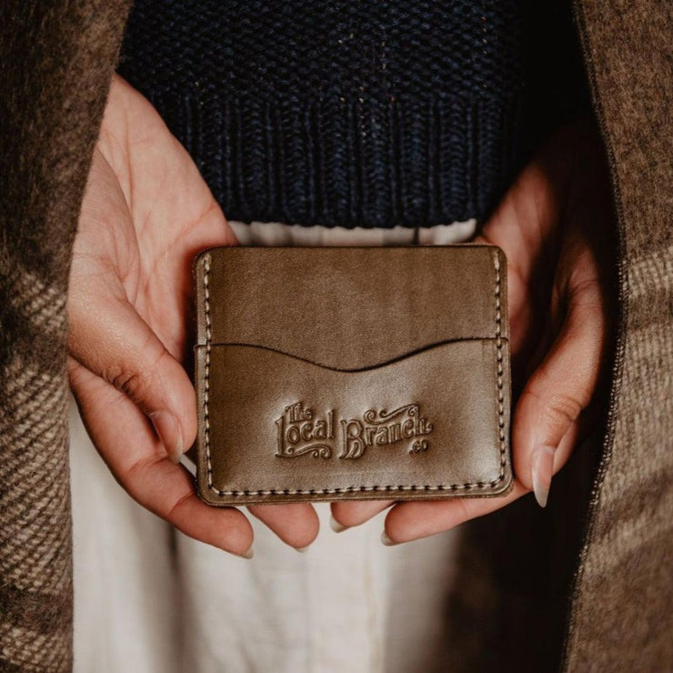 Leather Slim Wallet being held by two hands made by The Local Branch