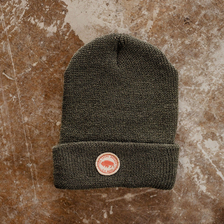 forest green colored beanie with small round patch bison and the local branch usa made